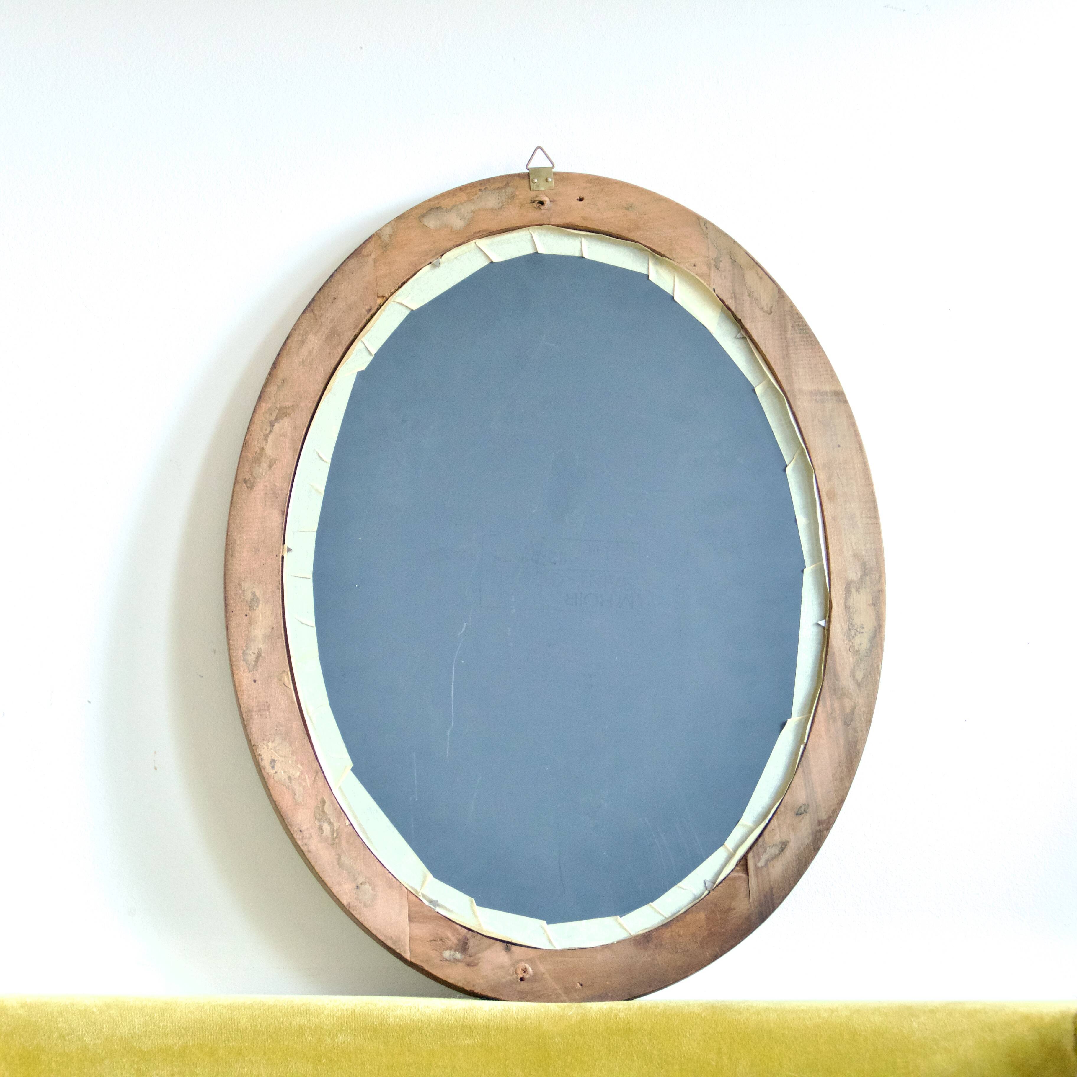 Antique oval mirror in carved wood