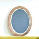 Antique oval mirror in carved wood