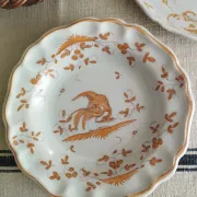 Pair of antique plates with a bird of paradise design in the style of Moustiers.