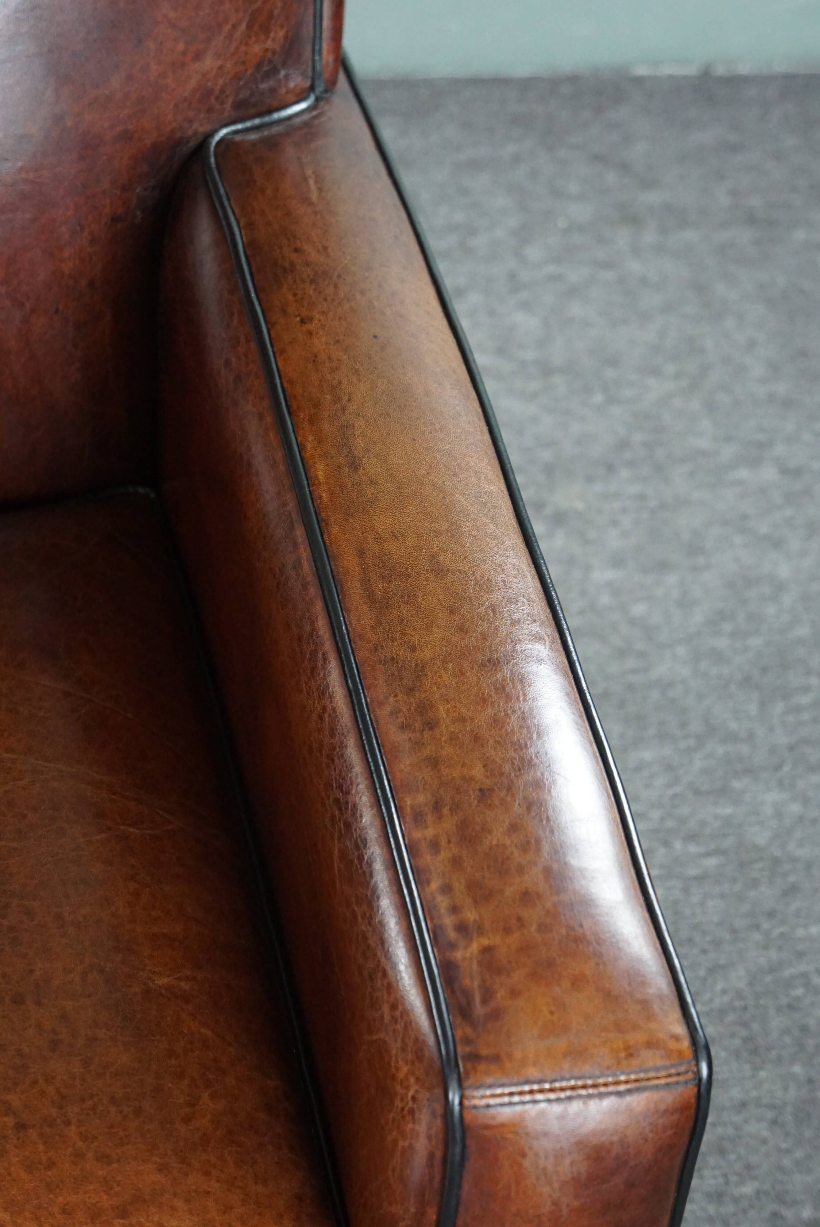 A very beautiful set of 2 Art Deco design armchairs in sheep leather