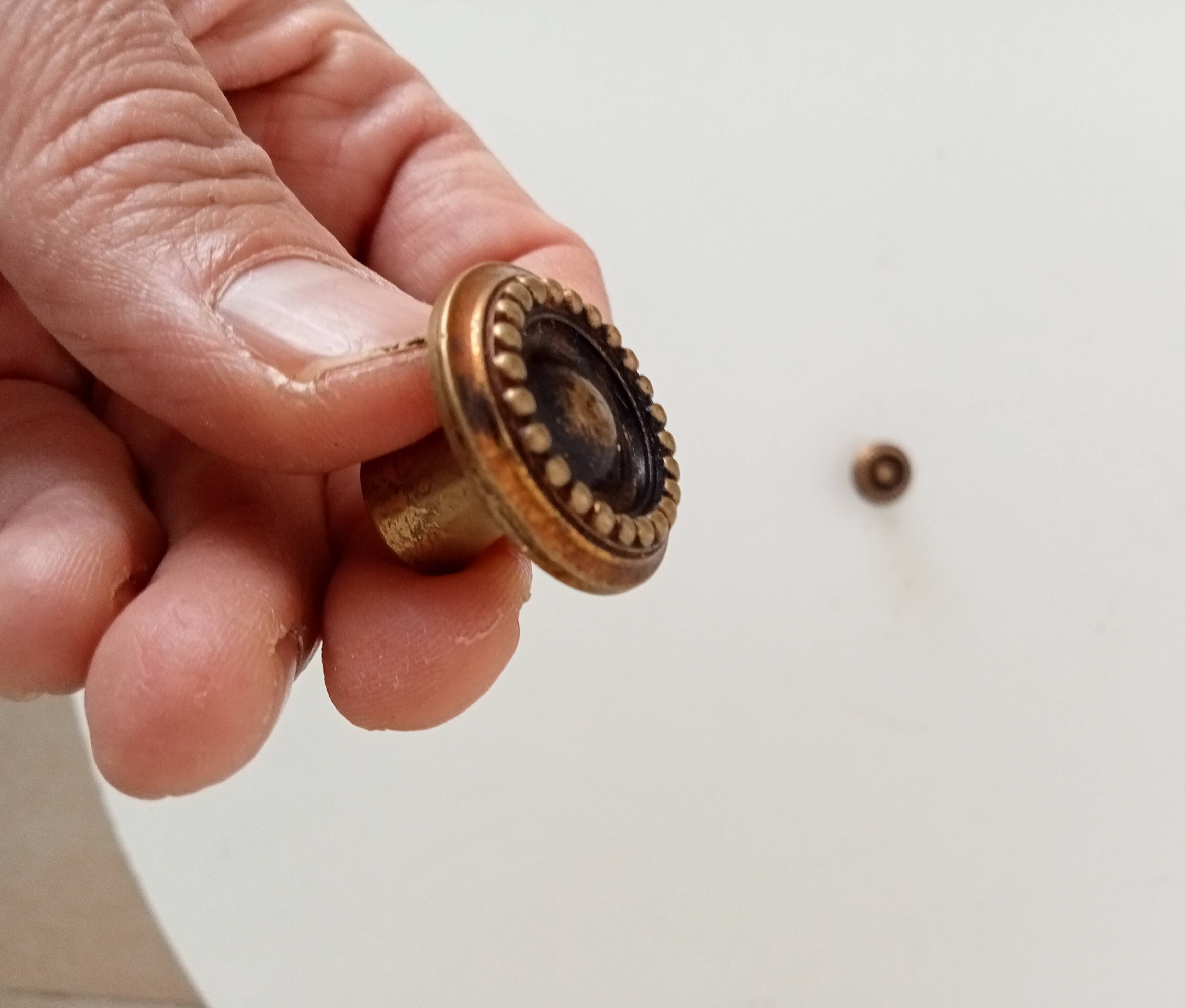 Pair of antique furniture knobs in gilded brass.
