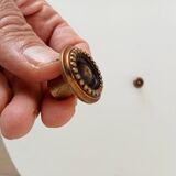 Pair of antique furniture knobs in gilded brass.