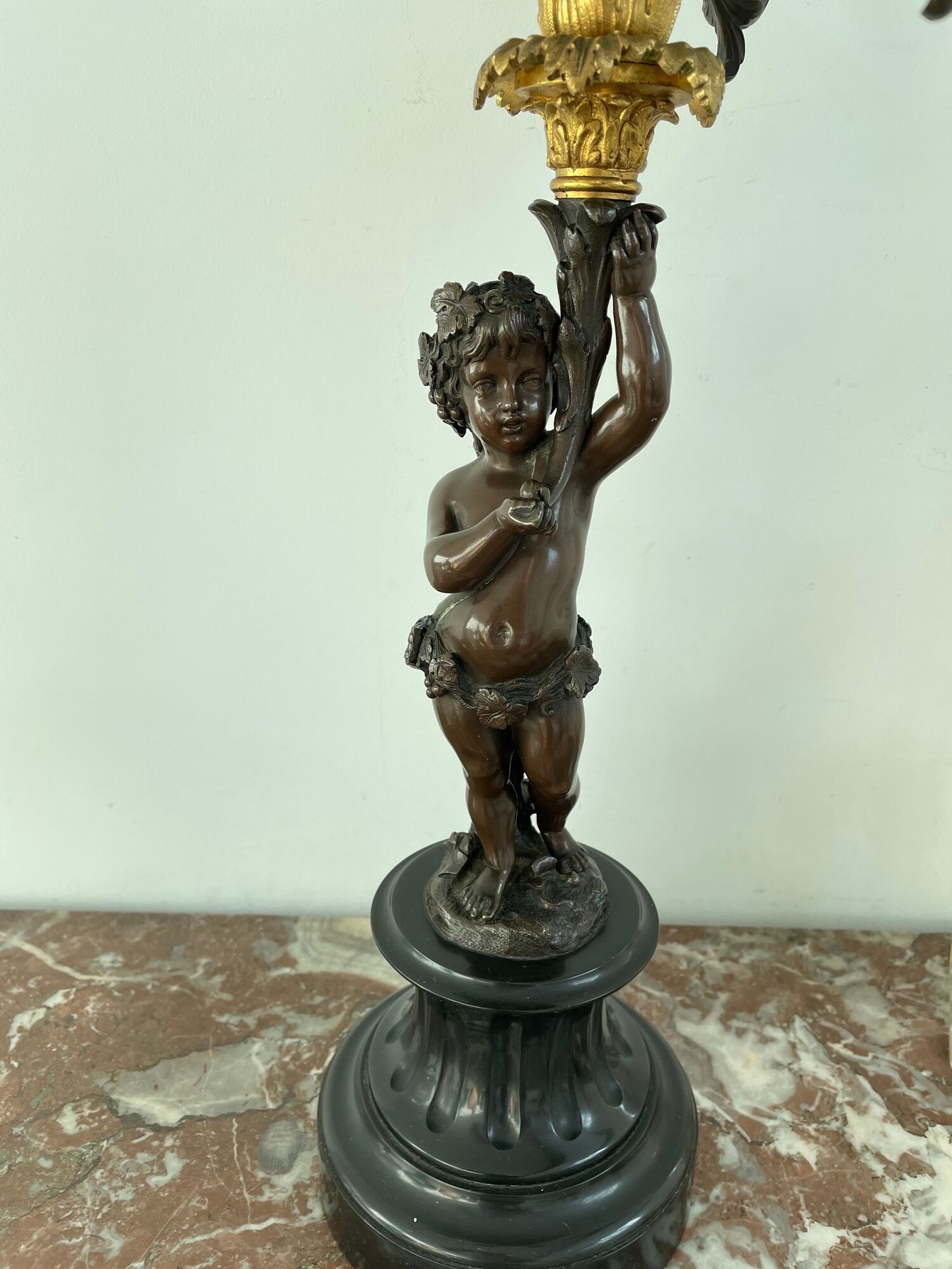 Candelabra with cherub in patinated bronze