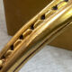 Small corner console in resin with a gold finish.