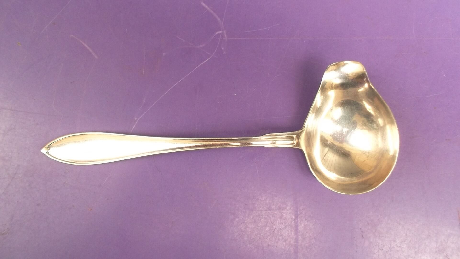 Silver metal sauce spoon