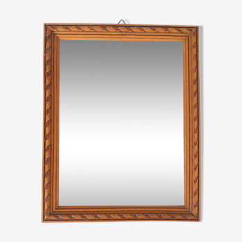 Small old wooden mirror with carved frame
