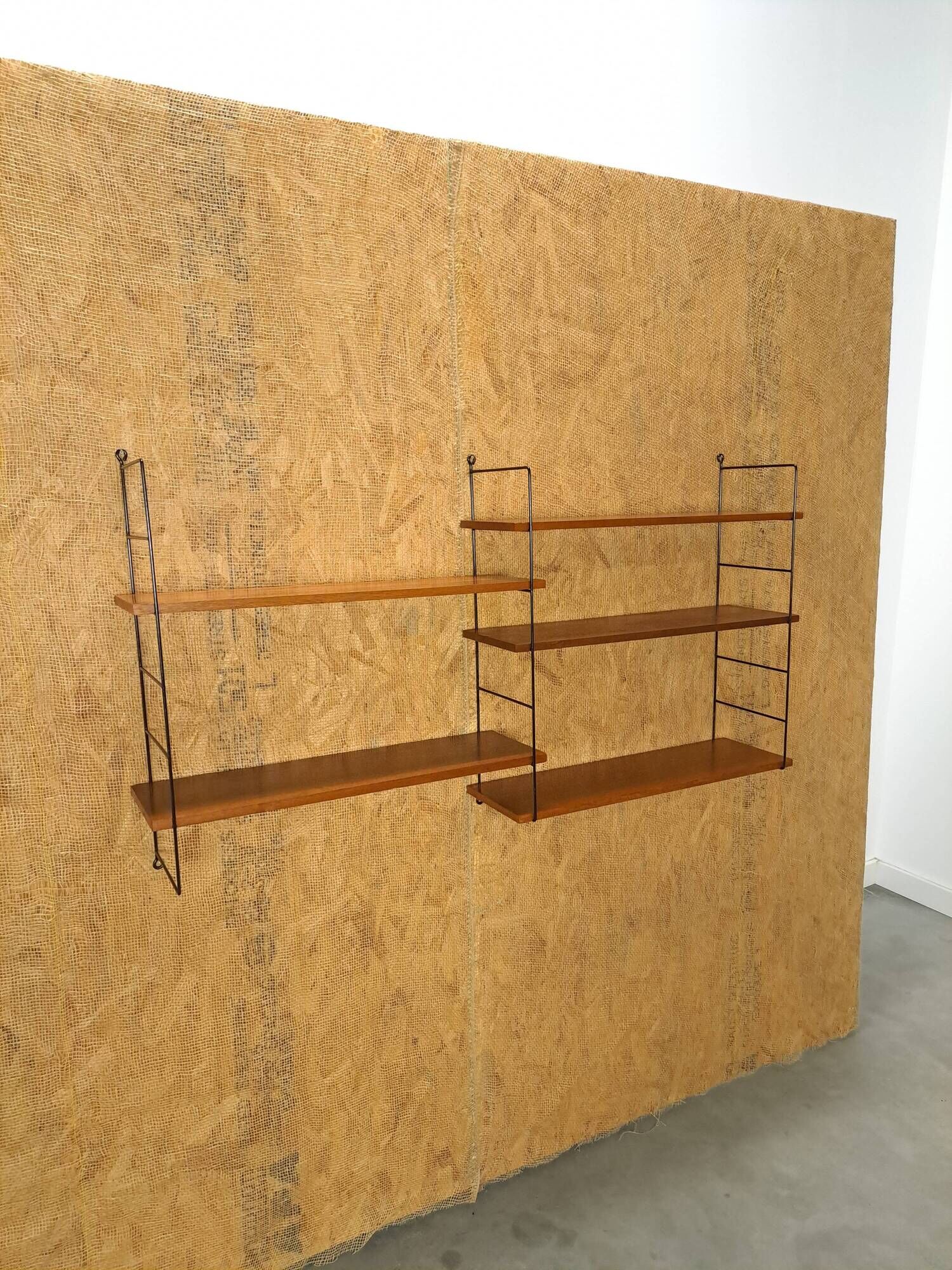 Wall rack with shelves and steel holders, dark wall system