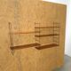 Wall rack with shelves and steel holders, dark wall system