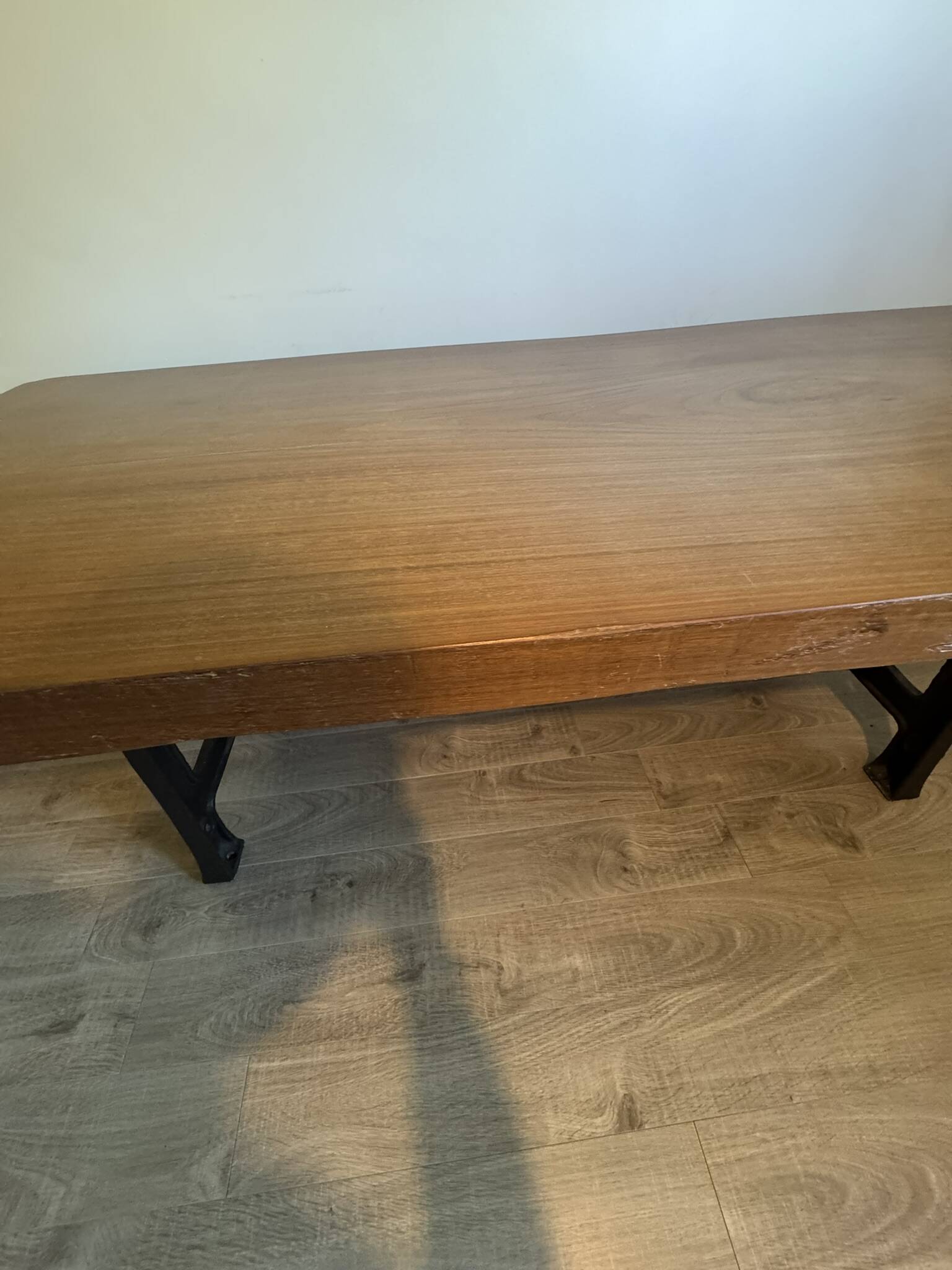 Industrial style table with a mahogany top.