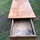 Antique farmhouse table in solid cherry wood with 2 drawers and 1 pull-out at the end with turned legs.
