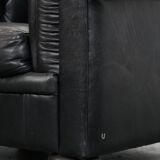 Comfortable black chesterfield armchair made of cowhide leather