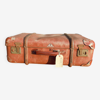 brown suitcase with wood