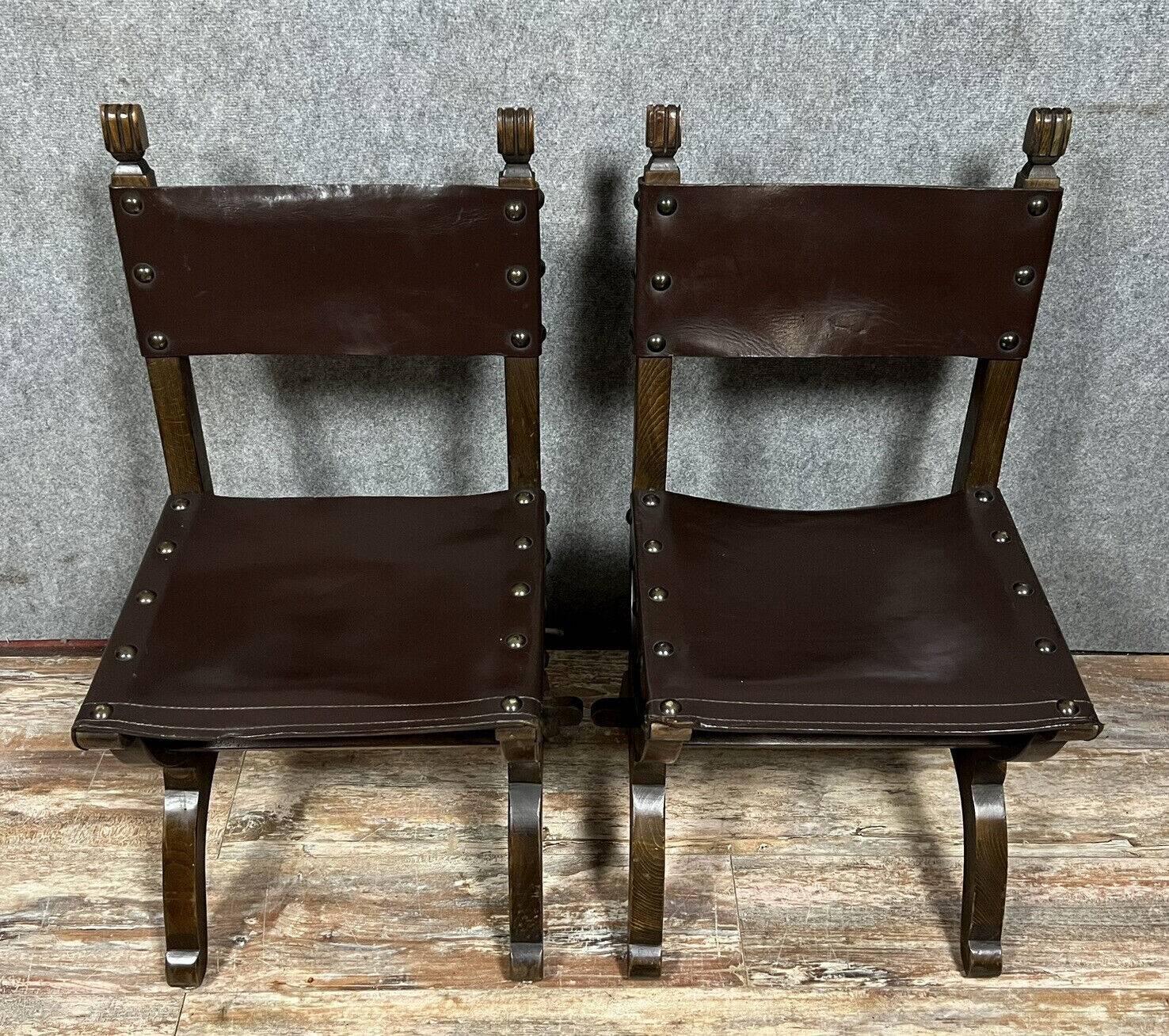 Pair of medieval style chairs in solid wood and leather, 19th century, circa 1850