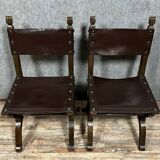 Pair of medieval style chairs in solid wood and leather, 19th century, circa 1850