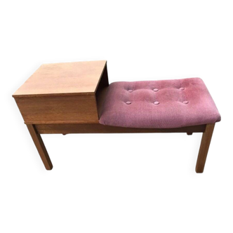Mid-century teak telephone bench with bright pink tufted seat and side table.