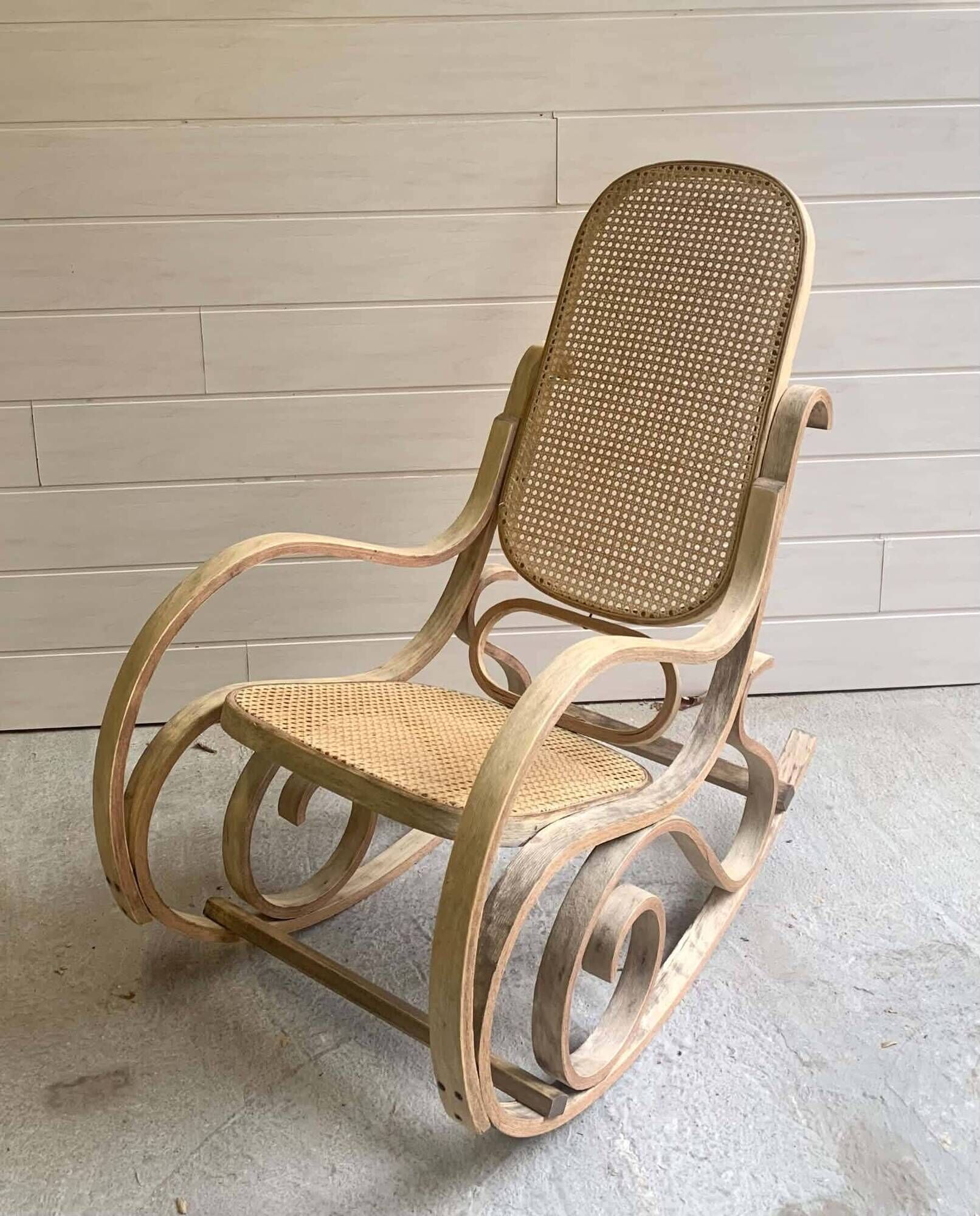 Rocking chair with a cane seat and backrest.