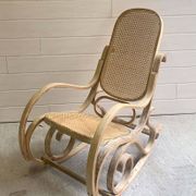 Rocking chair with a cane seat and backrest.
