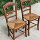 2 solid oak and straw wood chairs