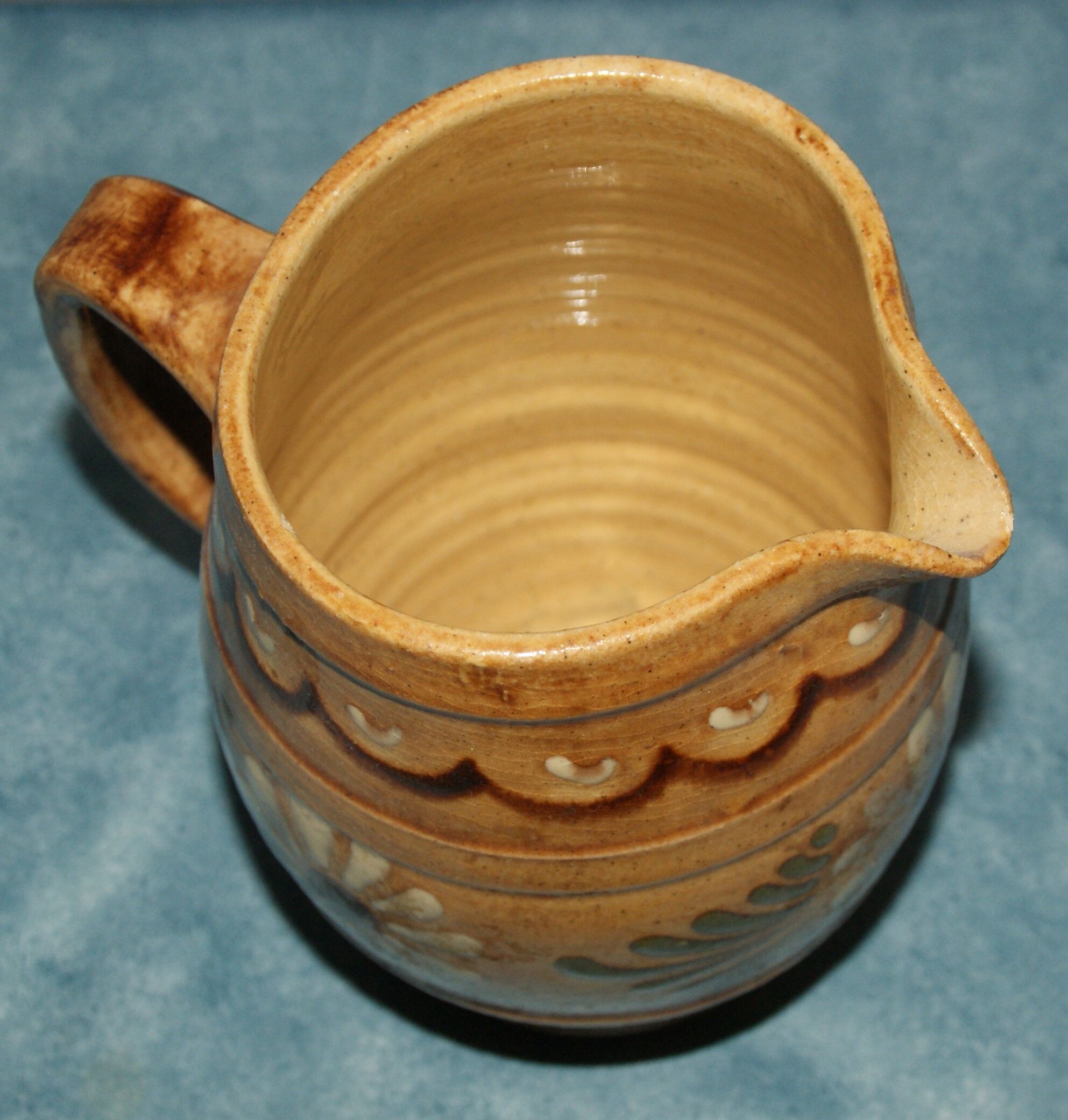 Glazed terracotta pitcher decorated with friezes and flowers