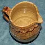 Glazed terracotta pitcher decorated with friezes and flowers