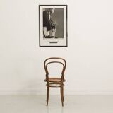 Bistro chair with curved wooden armrests and canning seat
