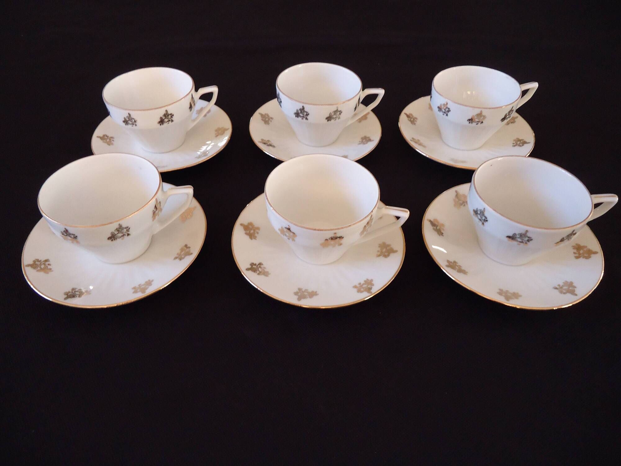Set of six Art Deco white fine porcelain coffee cups and saucers