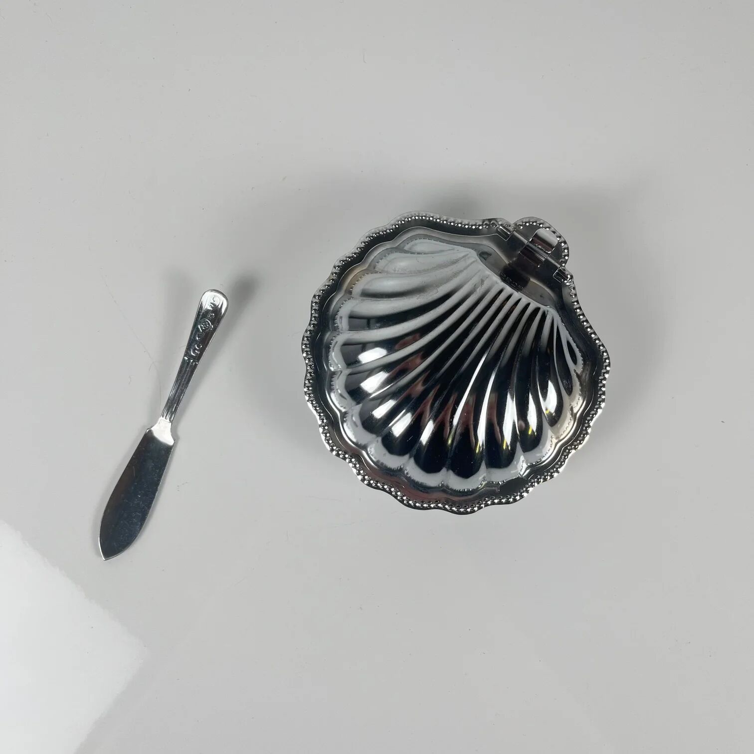 Metal shell butter dish with blue insert, 1970 with knife.
