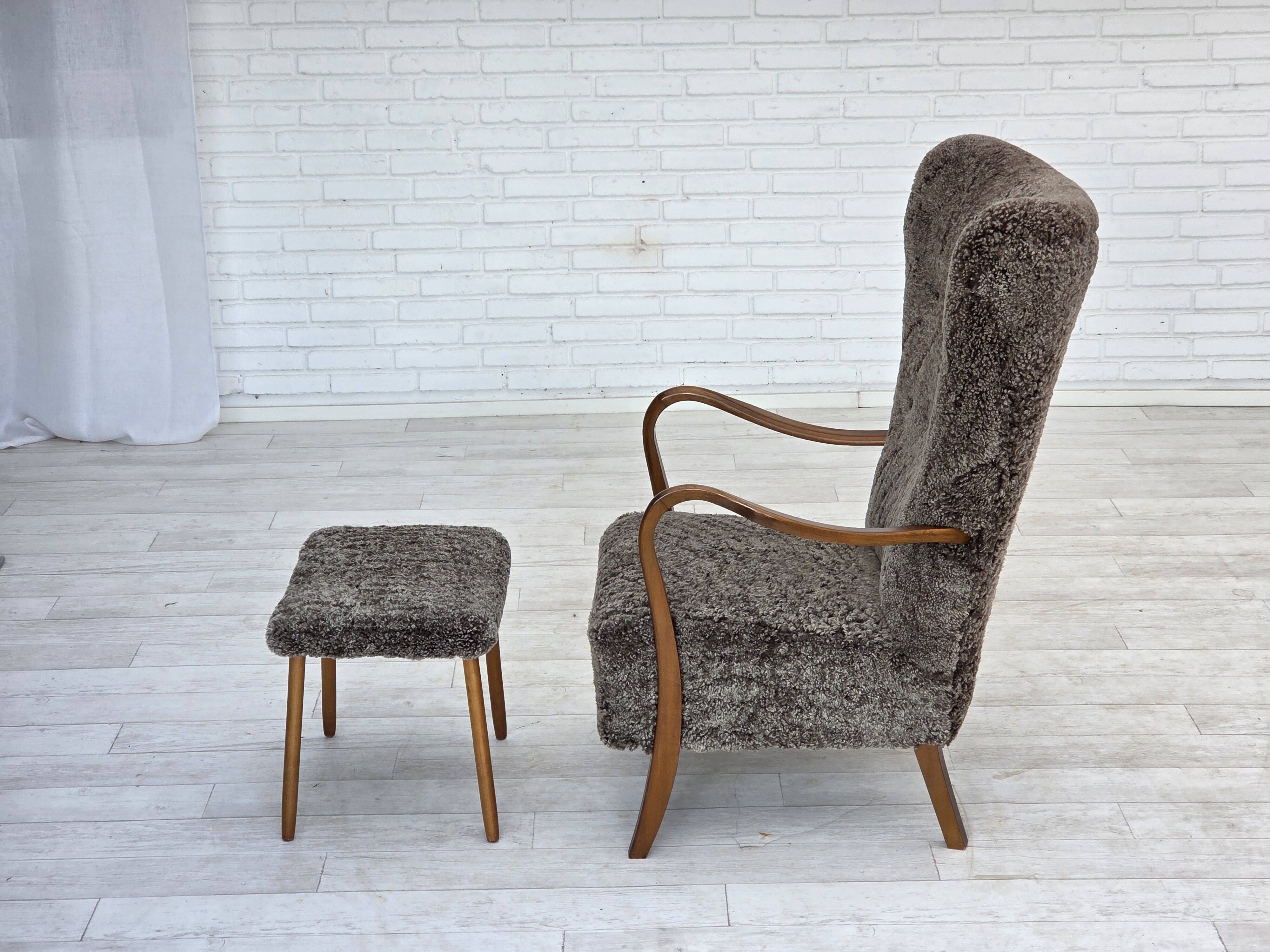 1960s, reupholstered Danish armchair, with stool, genuine sheepskin.