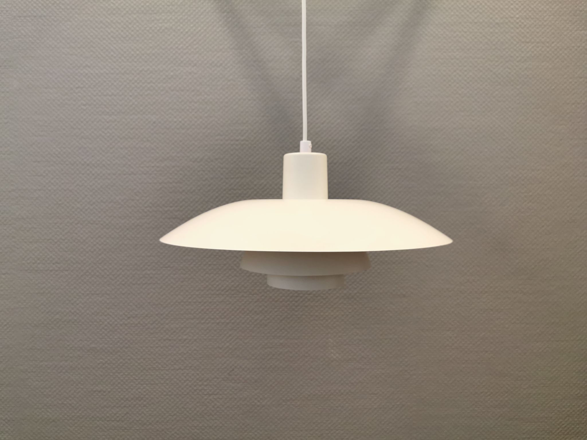 Older ph 4/3 hanging lamp, in white, with original orange suspension disk.