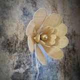 Flower wall light made of rattan and raffia petals