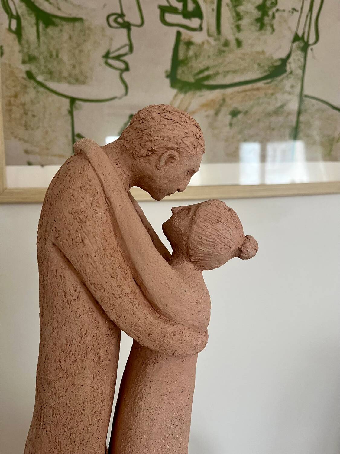 Sculpture of a couple entwined in grog clay.