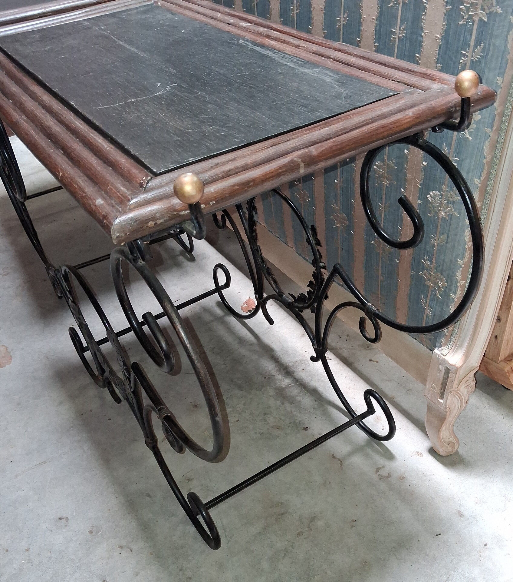 Pair of wrought iron and blackened wood consoles from the mid-20th century.
