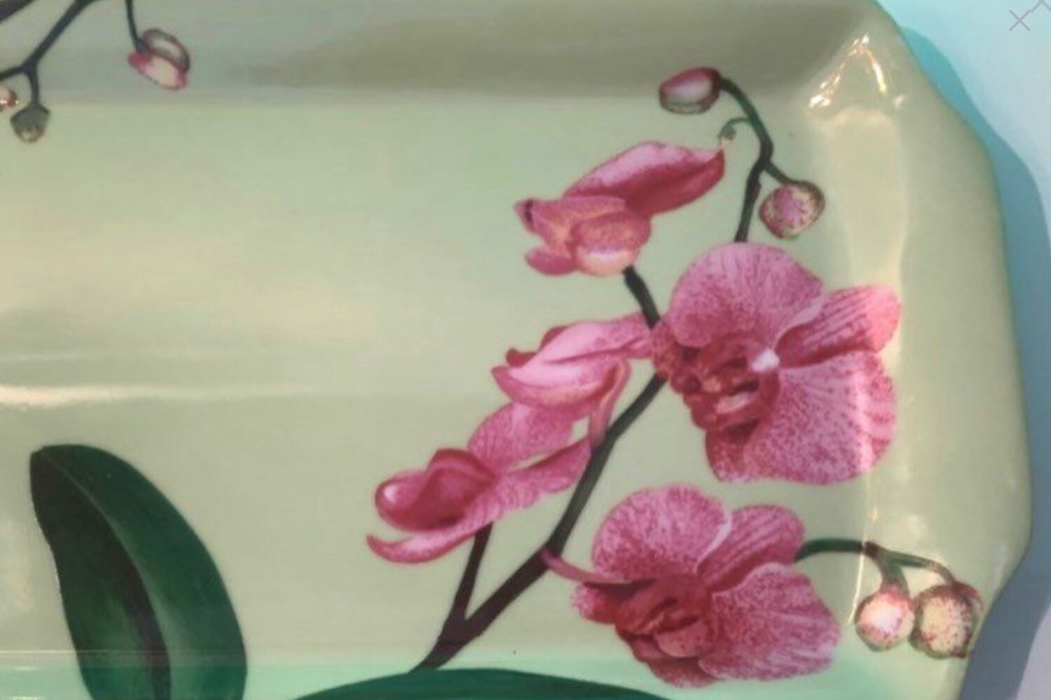 Cake dish with fuchsia orchids