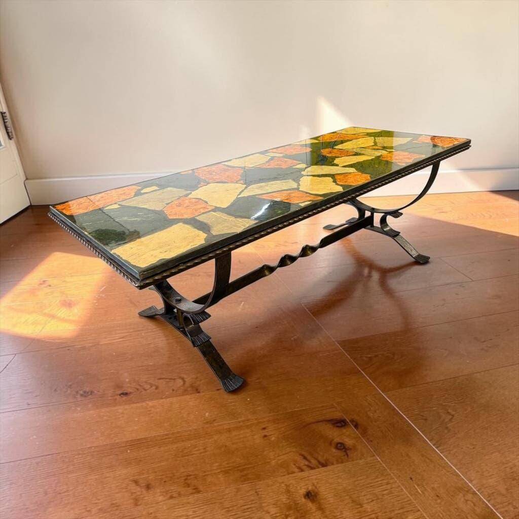 Vintage stone coffee table with a cast iron frame.