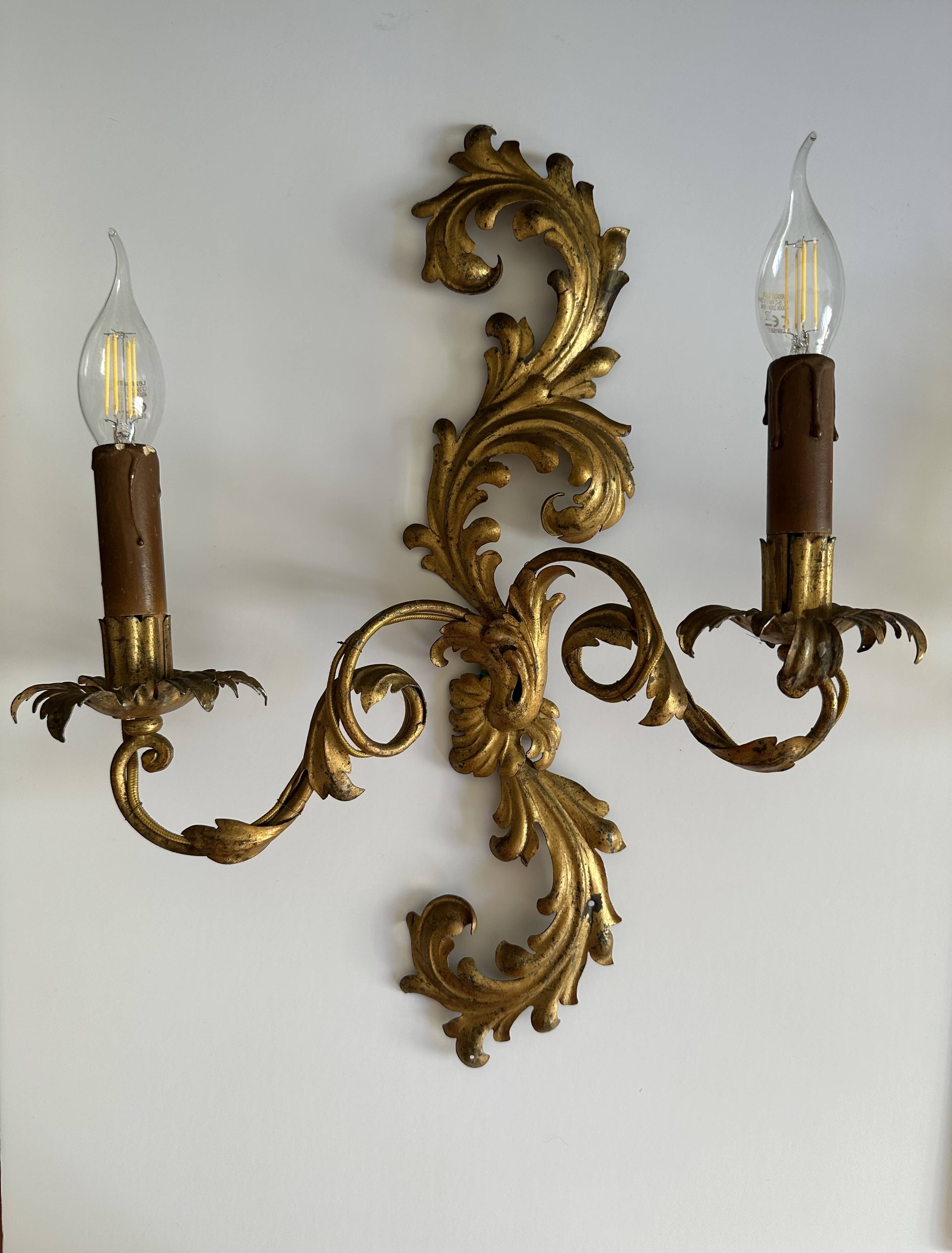 Pair of Italian Hollywood Regency wall lights in iron and gilded sheet metal.