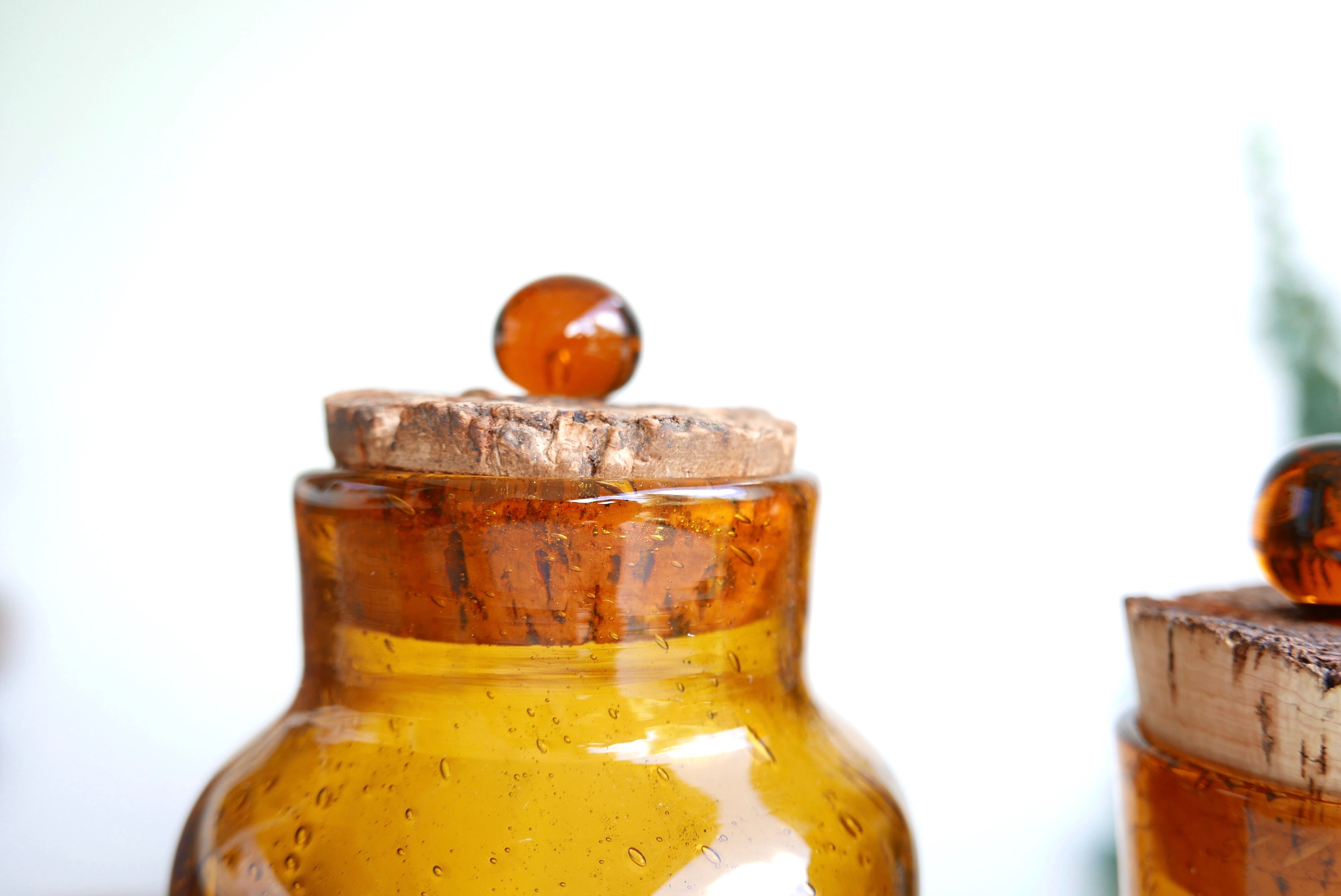 2 amber blown glass jars, cork stoppers