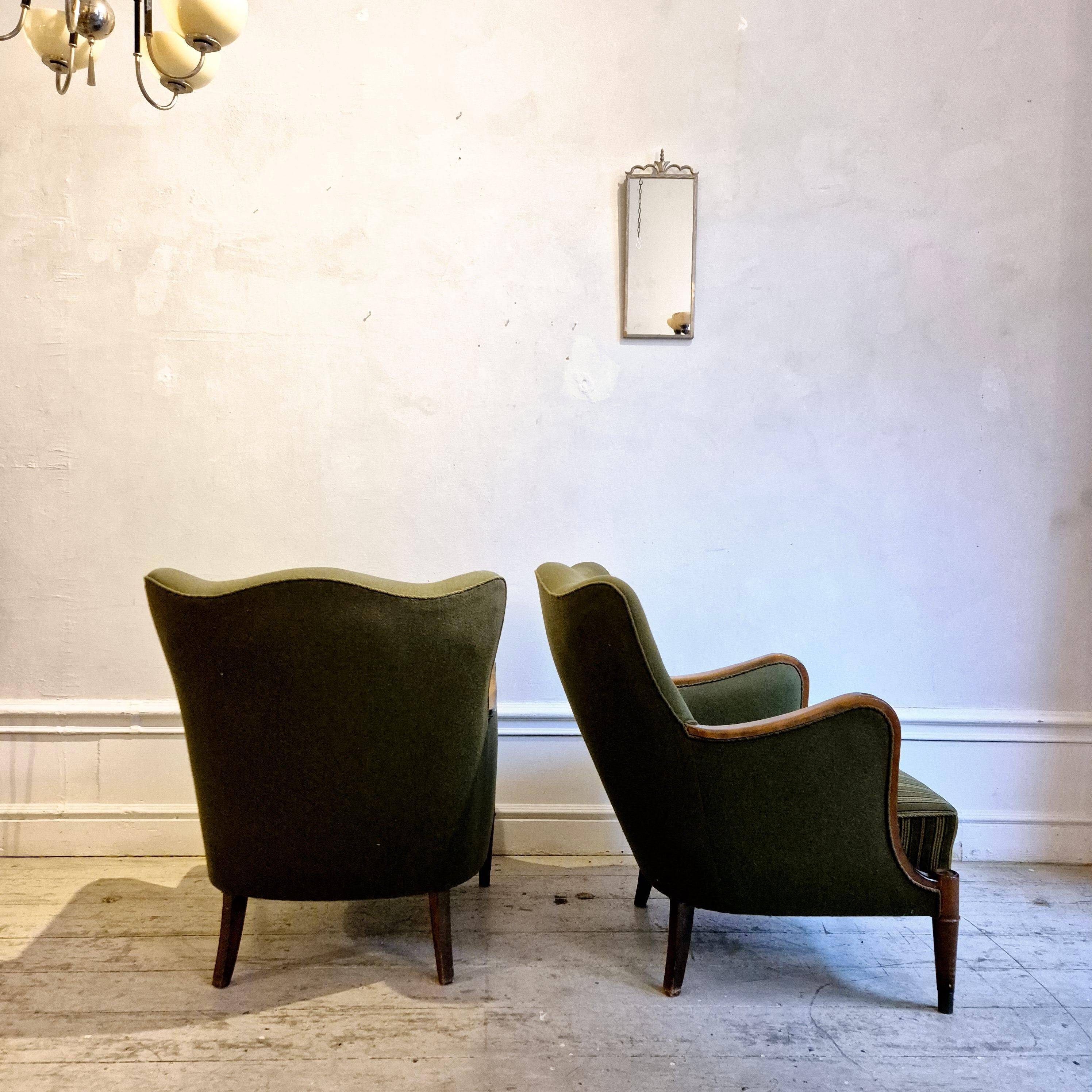 Modern Danish armchairs by Alfred Christensen. Beautiful shape, brass legs.