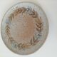 Speckled stoneware plate with floral decoration