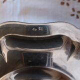 Sauce boat on a scalloped tray in silver metal