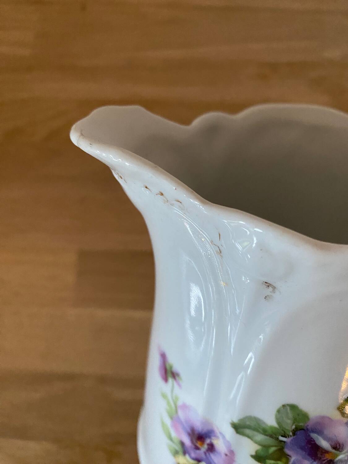 Old ceramic pitcher decorated with flowers