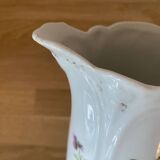 Old ceramic pitcher decorated with flowers