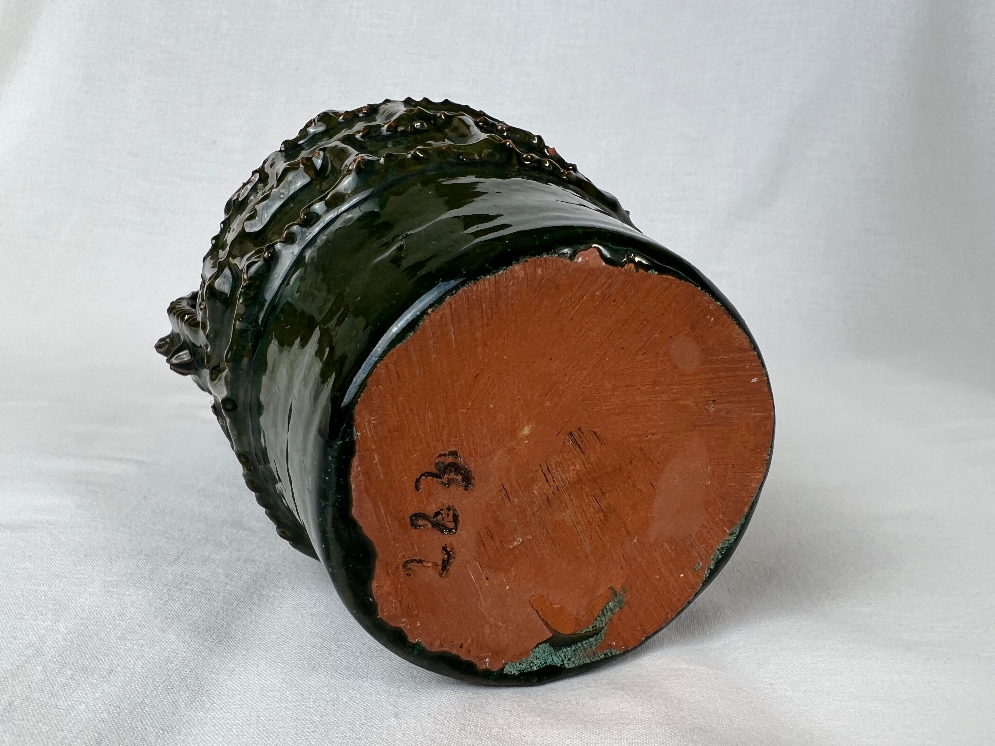 Terracotta jar with dark green handles