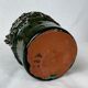 Terracotta jar with dark green handles