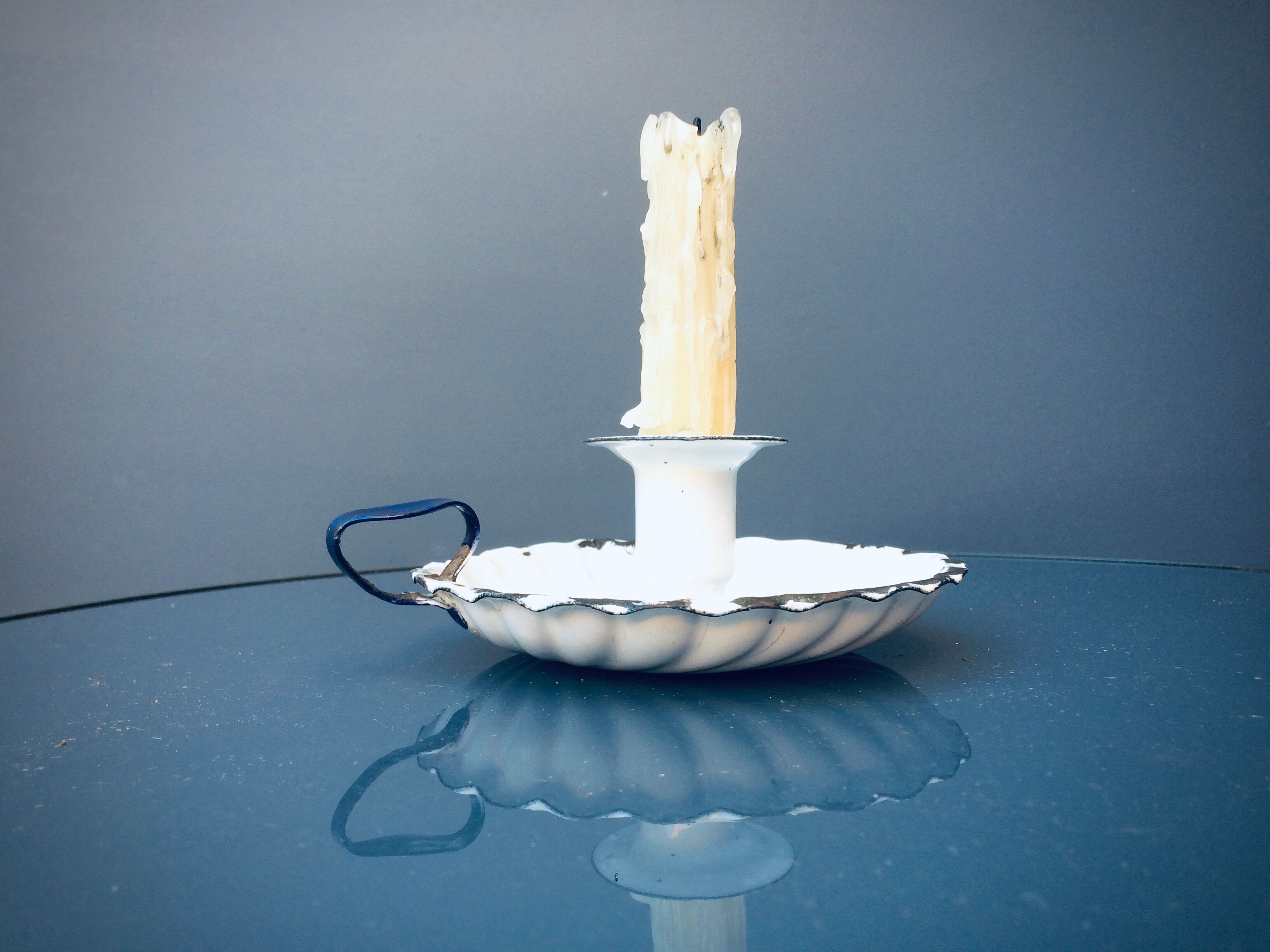 Old white enamelled candlestick