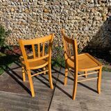 Pair of honey-colored luterma bistro chairs
