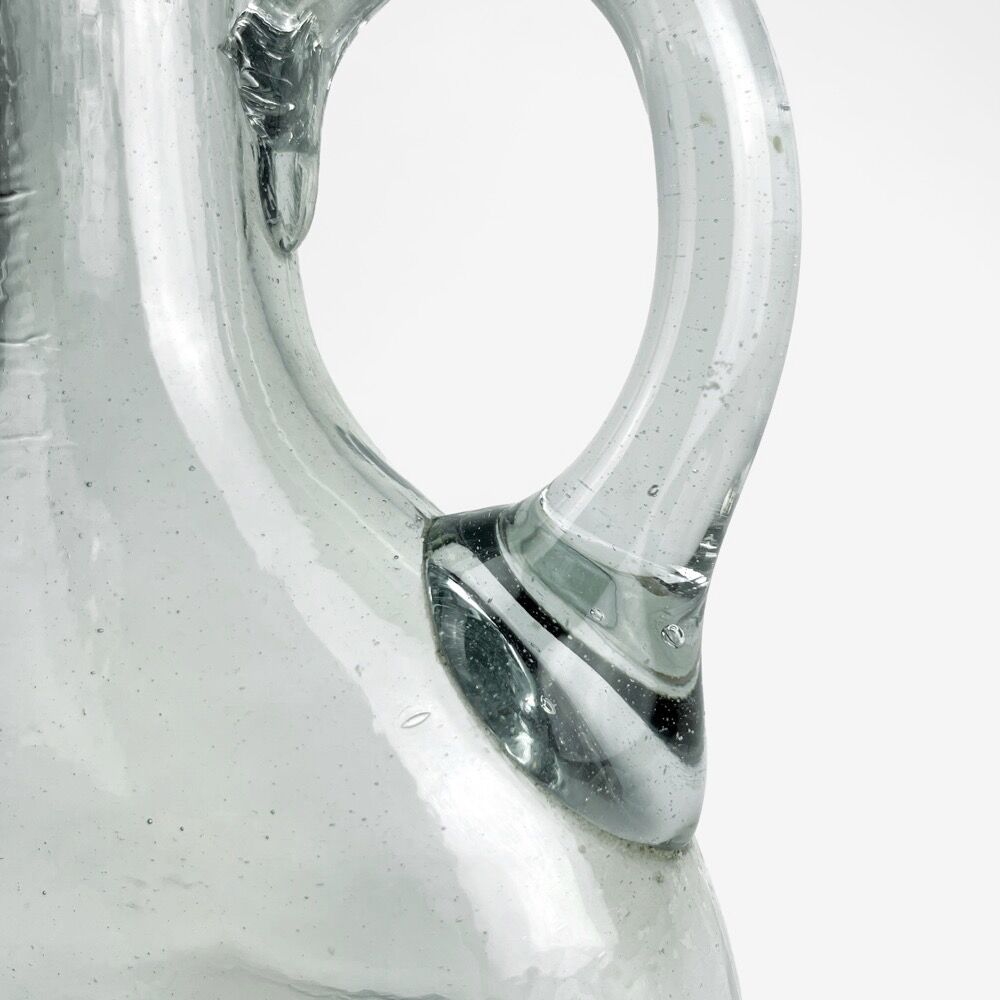 Antique water jug made of thick blown glass