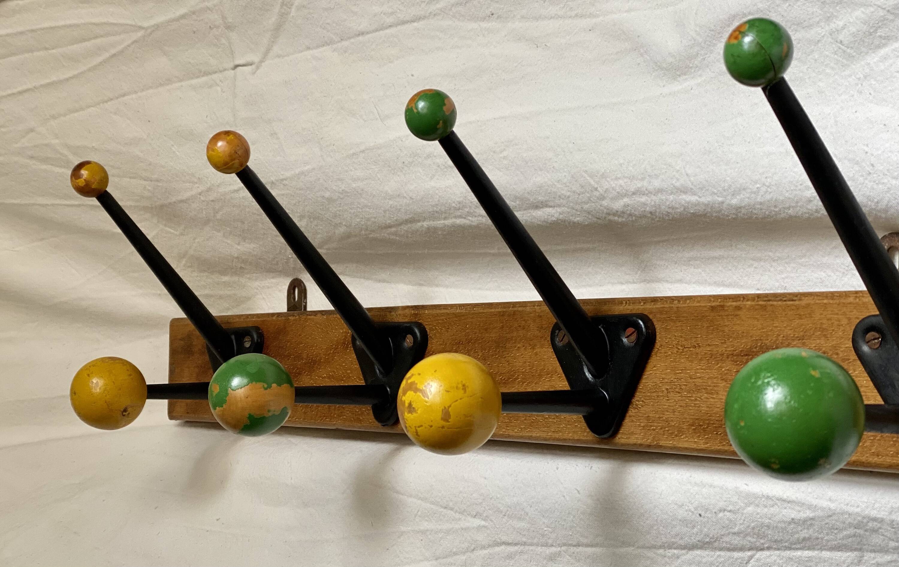 Coat rack with 5 double metal hooks and vintage wooden balls from the 1950s.