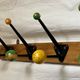 Coat rack with 5 double metal hooks and vintage wooden balls from the 1950s.