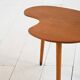 Biomorphic teak and brass side table from the 1950s–1960s