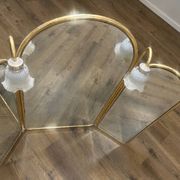 Vintage triptych mirror in brass with wall lights.